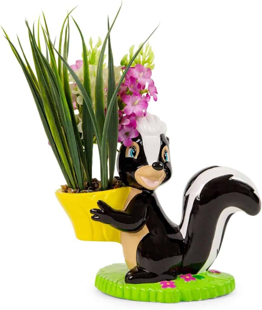 Cute skunk-shaped plant holder with pink flowers and green pot for St. Patrick's Day.