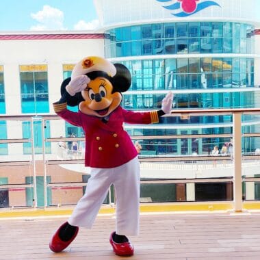 Mickey Mouse dressed as a chef on a Disney cruise ship deck.