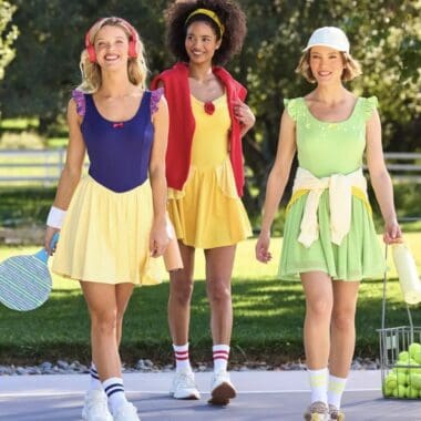Three girls in colorful tennis outfits enjoying outdoor play.