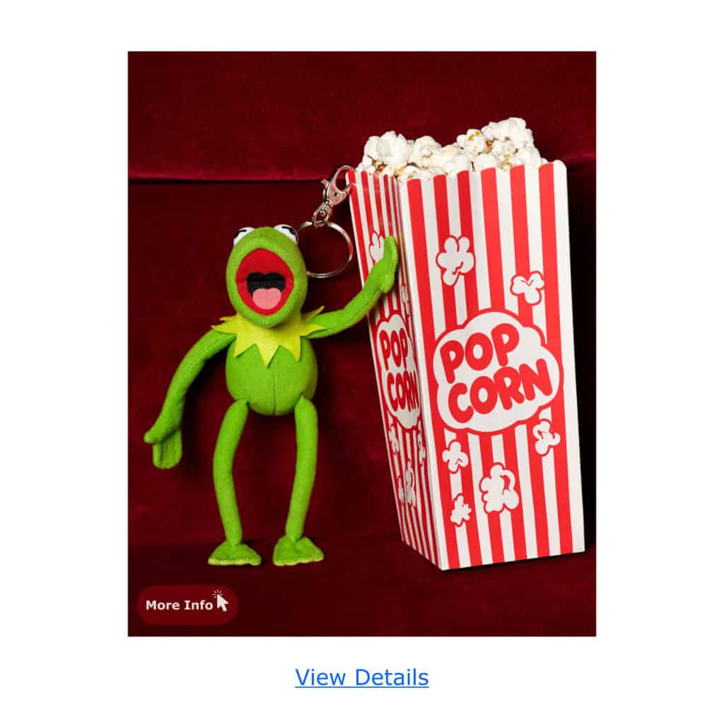 Kermit the Frog plush keychain next to a striped popcorn bucket filled with popcorn.