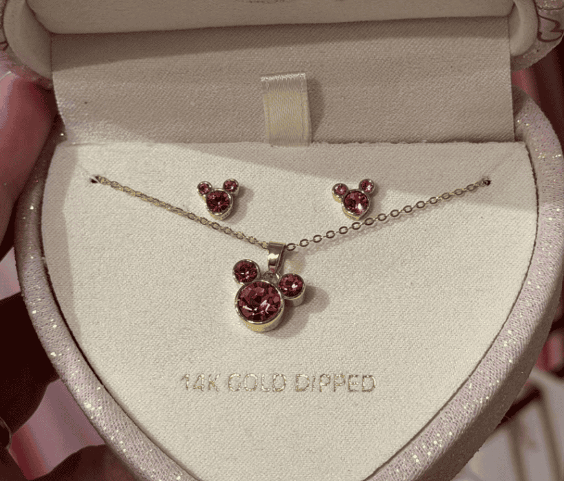 Gold-tone Mickey Mouse necklace and stud earrings with pink gemstones, perfect Disney fashion accessory.