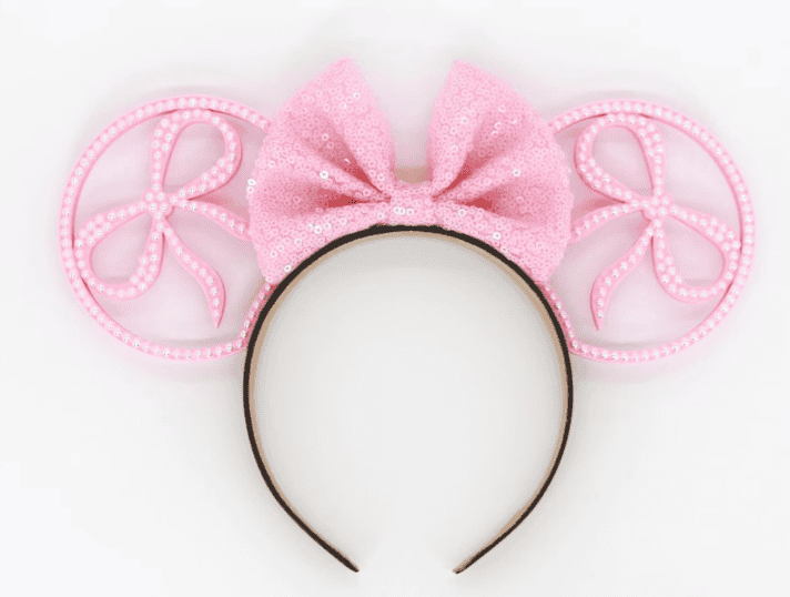 Pink coquette mouse ears headband with a large bow, perfect for Disney fashion and romantic accessor.