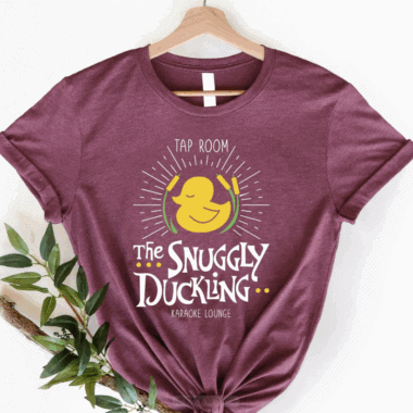 Snuggly Duckling T-shirt with karaoke lounge graphic, perfect for Disney fans and casual wear.