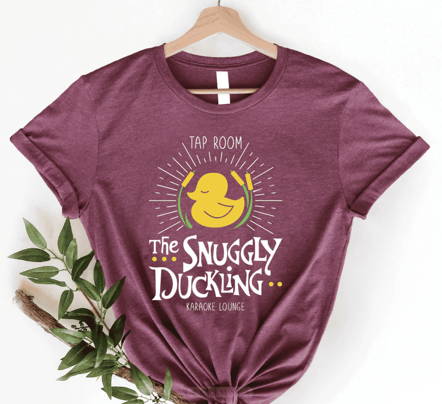 Snuggly Duckling T-shirt with karaoke lounge graphic, perfect for Disney fans and casual wear.