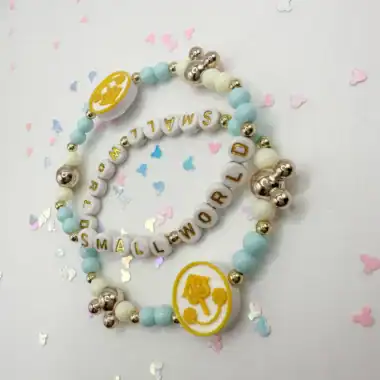 Themed baby girl bracelet with pastel beads and charms.
