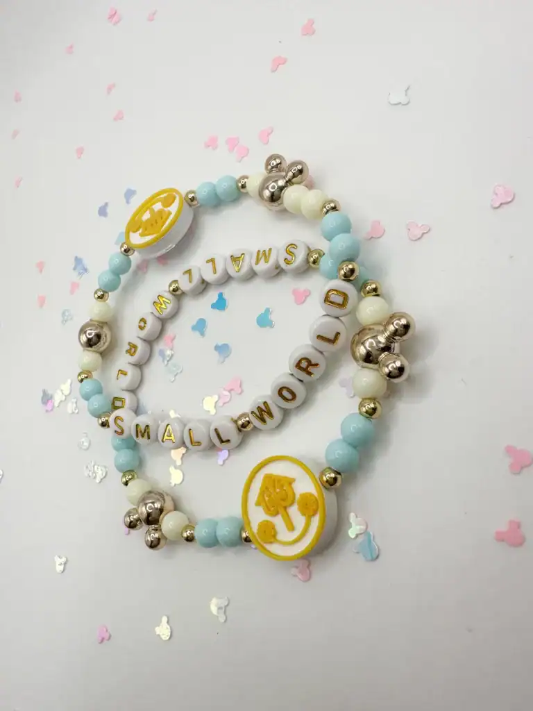 Themed baby girl bracelet with pastel beads and charms.
