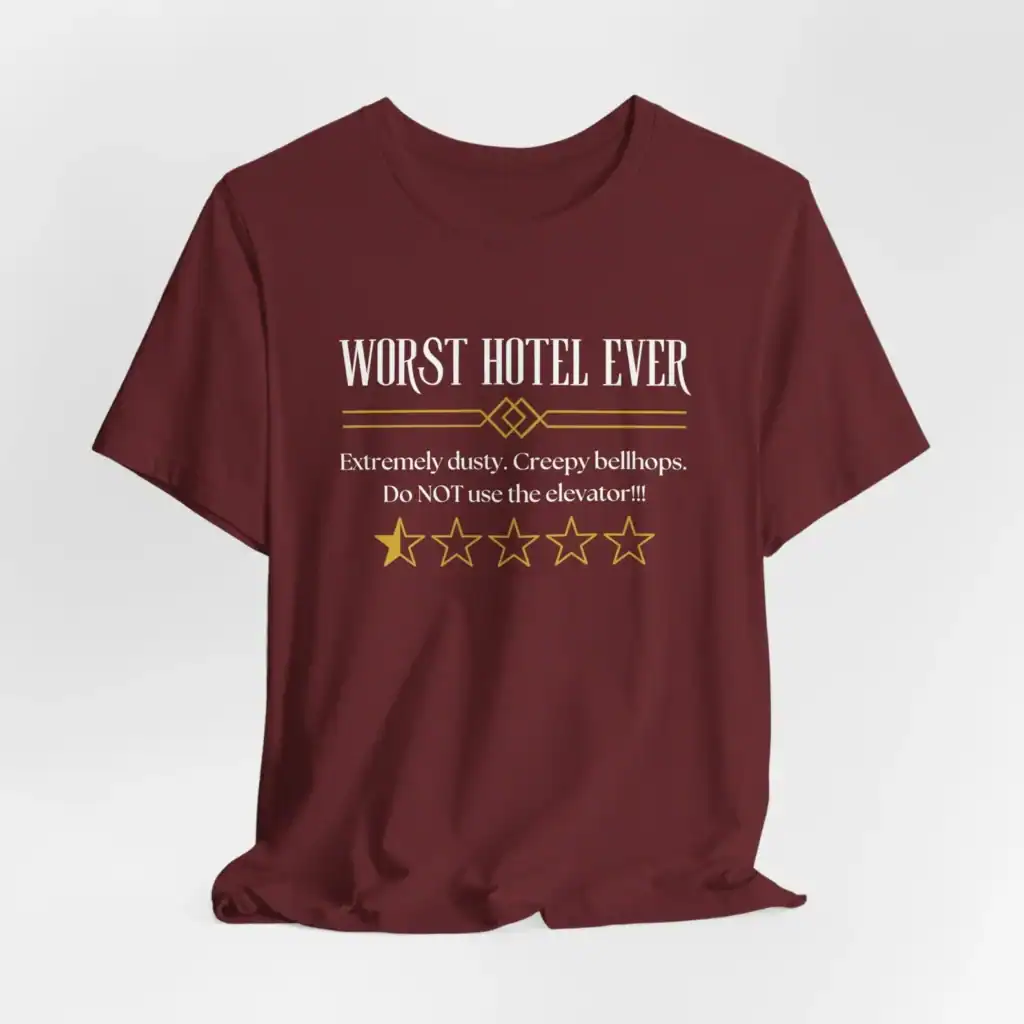 Maroon T-shirt with "Worst Hotel Ever" humorous text and star rating.