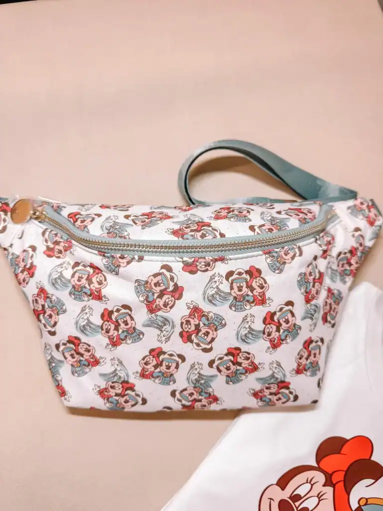 Mickey Mouse themed tote bag with colorful print and light blue handle.