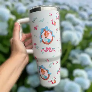 Disney princess-themed travel mug with floral and character designs.