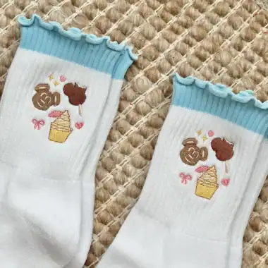 Inspired kids' socks featuring cupcakes and adorable character graphics.