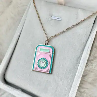 Enamel pendant necklace featuring Disney-inspired pastel colors and Mickey Mouse emblem, perfect for.