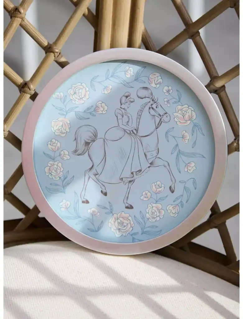 Enchanted girl riding a horse on a decorative Disney-themed plate with floral accents.