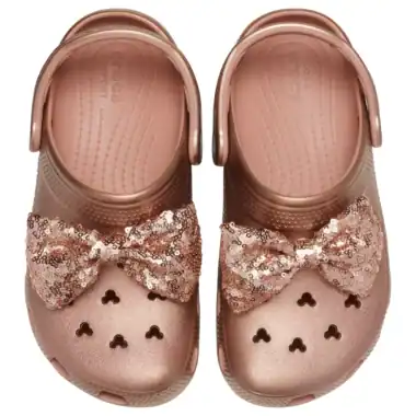 Pink Disney Crocs with sequin bow, heart cutouts, perfect for kids' Disney fashion.