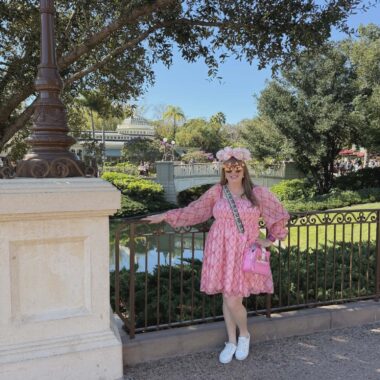 Disney outfit ideas for spring featuring a pink floral dress, matching accessories, and Disney-theme.
