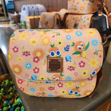 Colorful Disney-themed floral crossbody bag with animal prints and adjustable strap.