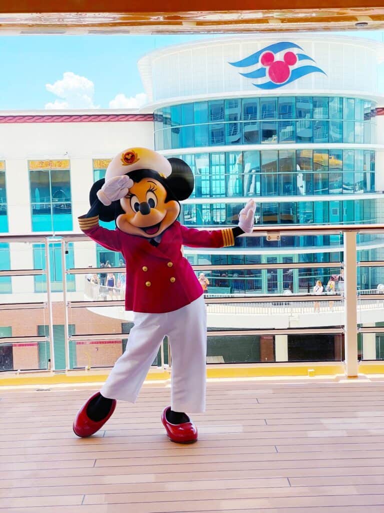 Mickey Mouse dressed as a sailor on Disney cruise ship deck.