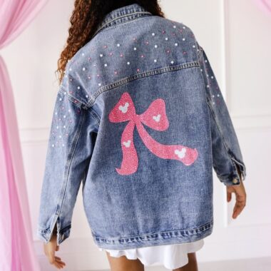 Disney fashion jacket with pink bow and decorative accents for a playful look.