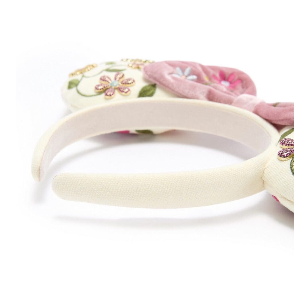 Beautiful embroidered floral headband with pastel pink and green details.