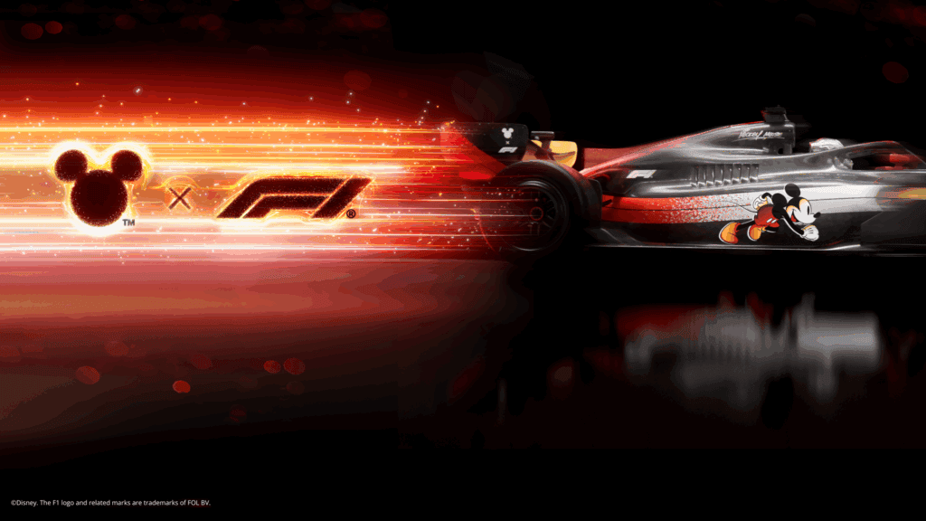 Disney and Formula 1 collaboration featuring Mickey Mouse and F1 car in a high-speed race scene.