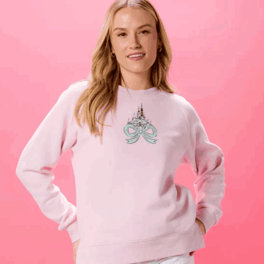 Pink sweatshirt featuring a Disney princess castle and bow design, perfect for Disney fans.