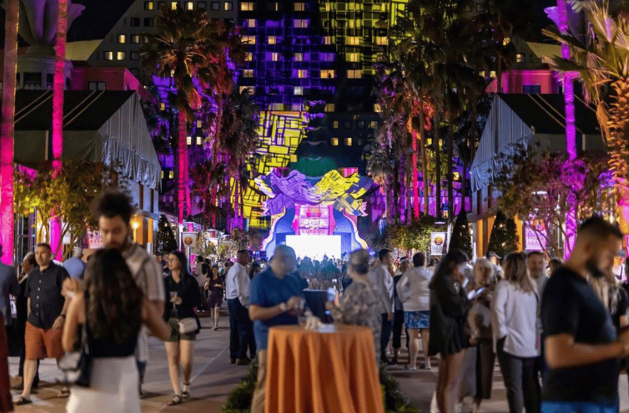 Vibrant night scene at the 2026 Swan and Dolphin Food & Wine Classic event.