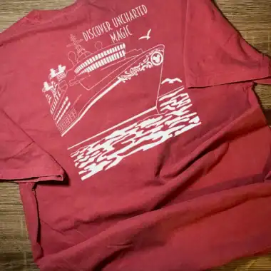 Unisex red T-shirt with white Disney-inspired design featuring a ship and ocean waves. Perfect for D.