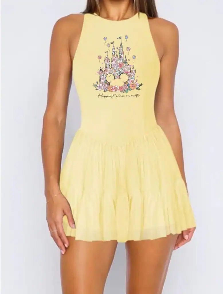 Yellow dress with Disney princess castle and floral design, perfect for fans.