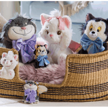Adorable Disney plush characters including cats, dogs, and tigers in a cozy basket.