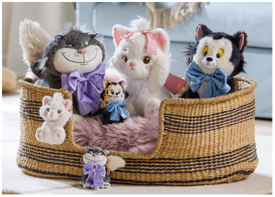 Adorable Disney plush characters including cats, dogs, and tigers in a cozy basket.