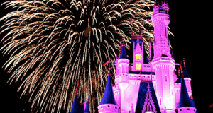 Cinderella Castle glows pink as dazzling golden fireworks light up the night sky at Disney World, thrilling the crowd below.