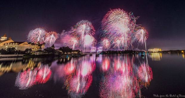 Dazzling fireworks burst over the water at Disney World, their vivid colors sparkling on the lake for an unforgettable spectacle.
