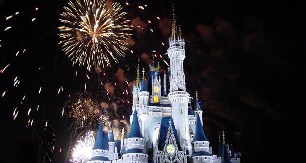 Cinderella Castle at Disney World sparkles under a night sky as vibrant fireworks light up the park for guests.