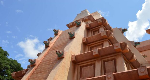 The iconic Mayan pyramid at Epcot’s World Showcase pops against a bright blue sky, inviting guests to explore its mysteries.
