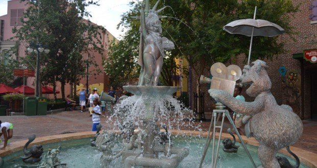 Muppet fountain with Miss Piggy and Fozzie Bear statues spraying water in Disney’s Hollywood Studios’ playful courtyard.