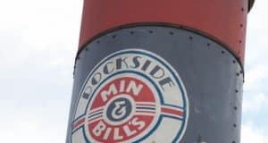 The iconic Dockside Diner Min & Bill's sign atop a red and blue structure welcomes guests at Disney’s Hollywood Studios.