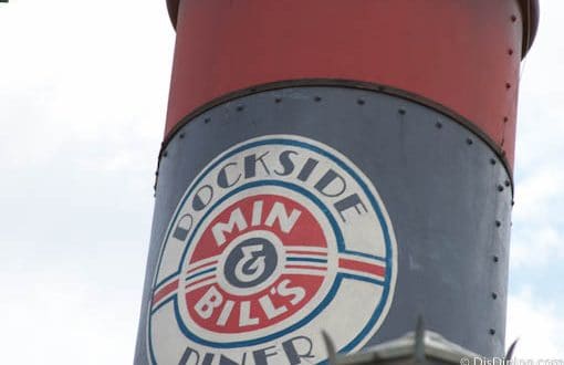 The iconic Dockside Diner Min & Bill's sign atop a red and blue structure welcomes guests at Disney’s Hollywood Studios.
