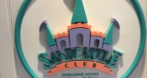 Sandcastle Club sign featuring a castle logo and hours for kids 3–12, promising magical childcare fun at Walt Disney World.
