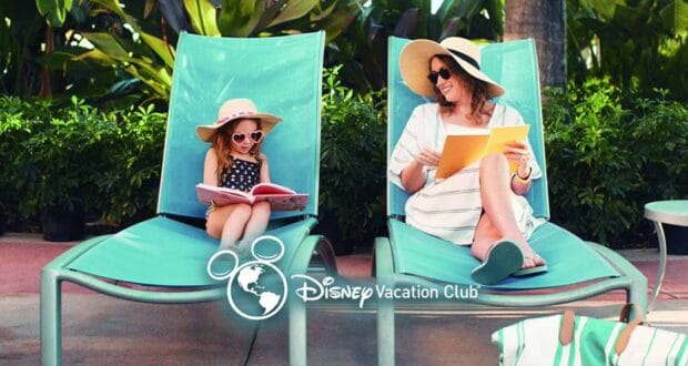 A woman and a young girl relax on turquoise lounge chairs outdoors, both wearing sunglasses and sun hats. The woman reads a book on Disney Vacation Club pros and cons and smiles at the girl, who looks at a picture book. Disney Vacation Club logo is overlaid.