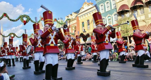 Toy Soldiers march and play instruments in a lively holiday parade on Disney’s festive streets, adding magic to the celebration.