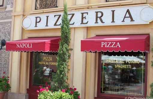 Via Napoli at Disney World beckons with bold red awnings and big windows tempting guests inside for authentic pizza and pasta delights.