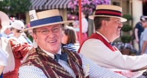 Dapper Dans in vintage attire and straw hats delight guests with a sunny outdoor performance on Main Street, U.S.A.