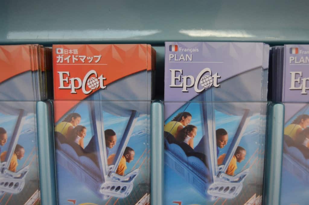 Japanese and French Epcot maps side by side in a brochure holder welcome Disney World guests to the parks' global adventures.