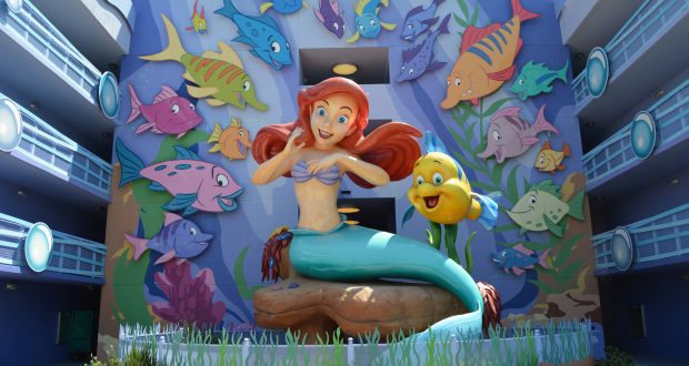 Ariel and Flounder shine in a lively mural with bright Disney fish, capturing the enchanting spirit of Walt Disney World.