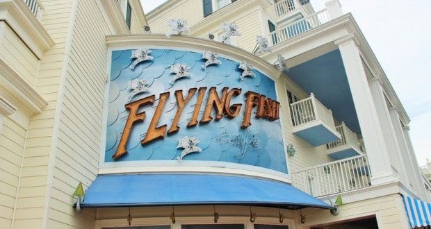 The whimsical blue-and-white Flying Fish Café at Disney’s BoardWalk features playful fish décor and a bold marquee sign.