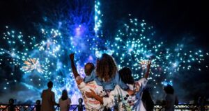 A family stands watching Luminous a Symphony of us at Epcot