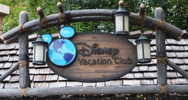 Disney Vacation Club sign with lanterns, blue Mickey-shaped map, and a cheerful "Welcome Home!" greeting below.