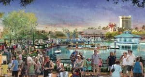 Guests explore a lively waterfront lined with shops and boats beneath a vibrant sky, capturing the energy of Disney World.