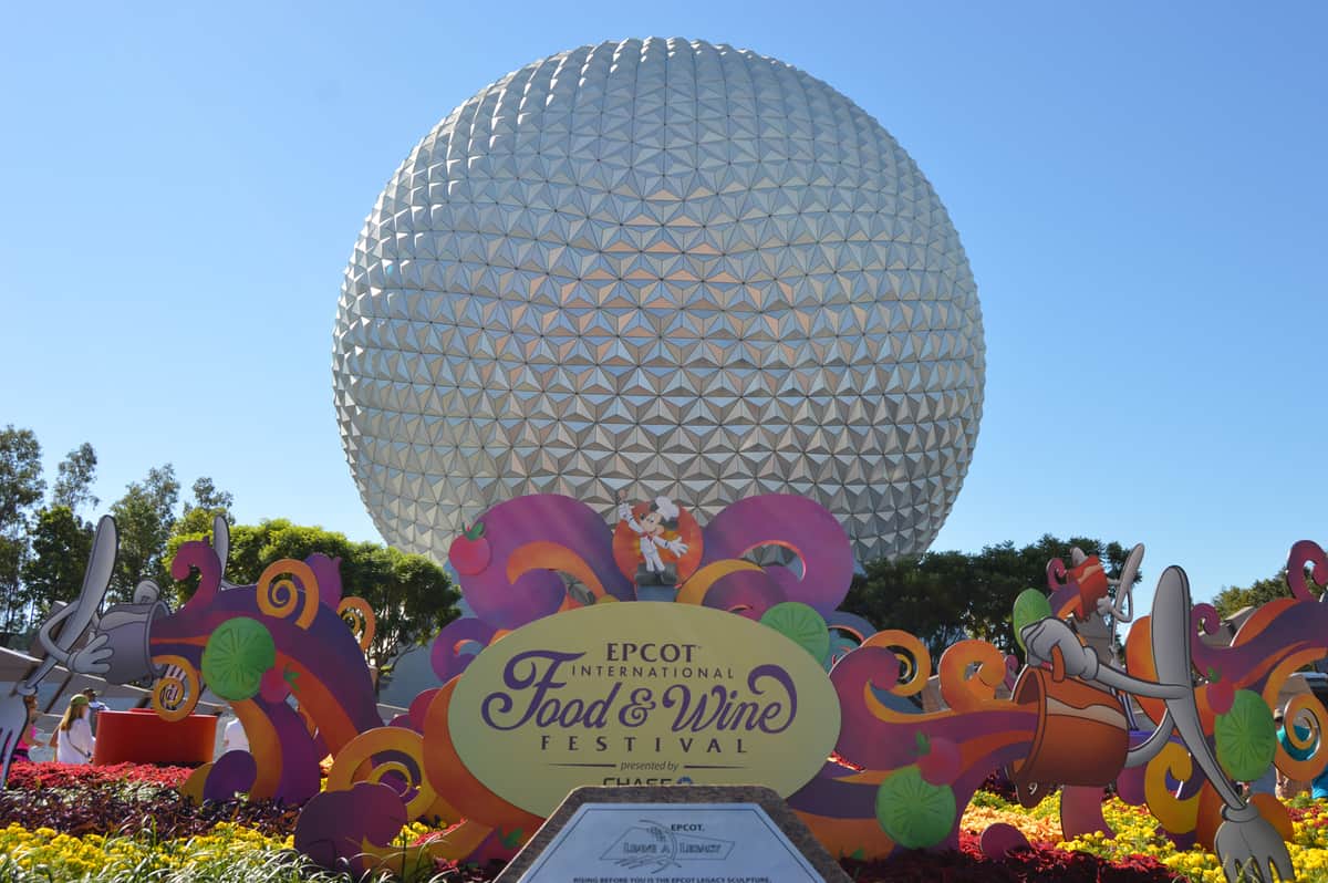 Spaceship Earth at Epcot gleams in the sunlight, decked out with vibrant Food and Wine Festival décor—pure Disney World magic.