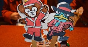Duffy in a Santa suit and LinaBell the fox in festive red greet fans as adorable character stick souvenirs at Shanghai Disneyland.