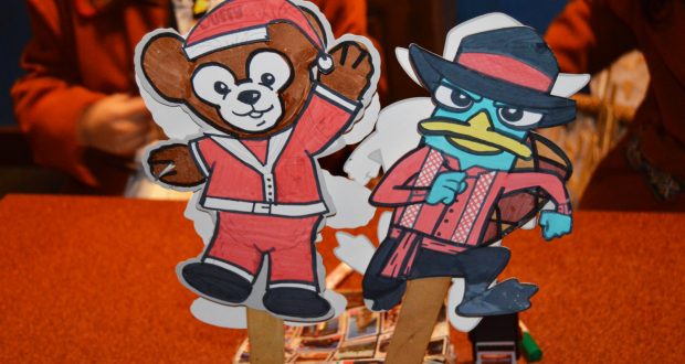 Duffy in a Santa suit and LinaBell the fox in festive red greet fans as adorable character stick souvenirs at Shanghai Disneyland.